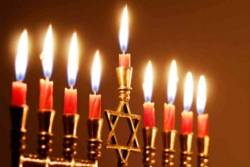 Fully lighted menorah with red candles