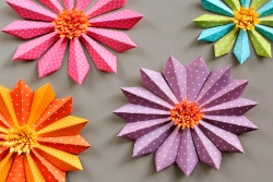 Dimensional paper flowers, purple orange green and blue in color