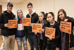 Teens and young adults with Reform Movement gun violence prevention signs