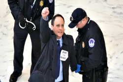 Rabbi Jonah Pesner wearing a Jews 4 Dreamers sign while being arrested by Capitol Police 