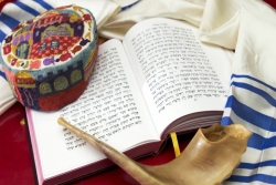 Tallit, machzor (High Holiday prayer book), traditional head covering, and shofar