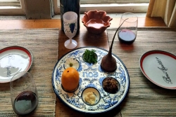 Seder table set with slightly nontraditional seder plate items as explained in this essay