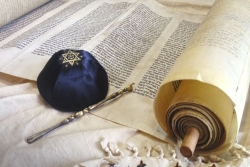 Torah scroll with a yad and a kippah