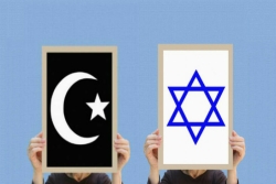 Islamic crest and Star of David signs held next to one another against a blue background