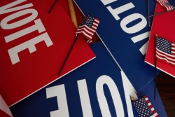 Three VOTE signs in red white and blue