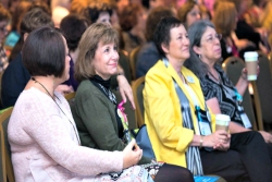 Smiling women sitting together at a Women for Reform Judaism event 
