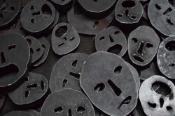Holocaust memorial artwork depicting abstract metal faces 