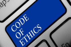 Blue key on computer keyboard that says Code of Ethics in white letters