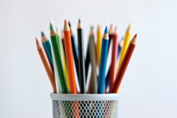 Colored pencils -- points up -- in a container