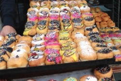 Trays of colorfully decorated donuts for Hanukkah