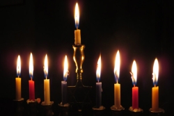 Hanukkah menorah with eight candles and the shamash all burning