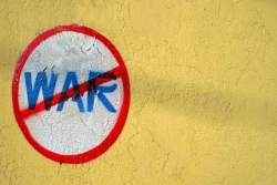 graffiti crossing out the text "war"