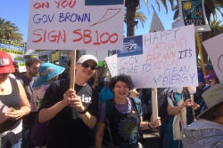 The authors at a climate change march, holding signs that read "Happy 5779, Gov. Brown it's time to sign SB 100 for Clean Energy!"