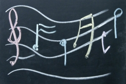 G-clef and musical notes written in chalk on a blackboard