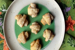 Plate of pineapple rugelach on a floral tablecloth