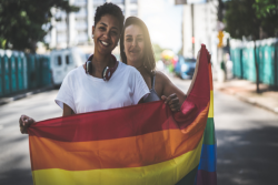Two women holding a pride flag