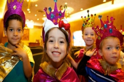 Four young kids in Purim costumes