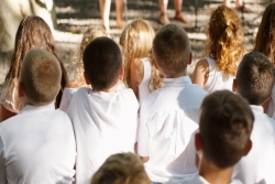kids in white shirts viewed from the back