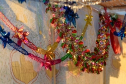 Shiny, colorful decorations strung in a sukkah