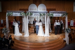Three Israeli wedding couples under the chuppahs at Washington Hebrew Congregation on March 26, 2019