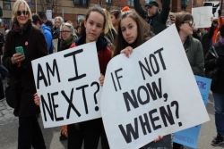 Two young girls with signs at the March for Our Lives