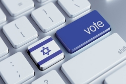 Computer keyboard with blue enter key that says Vote; key to the left is Israeli flag