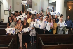 Community members in San Juan holding up the water filters sent by Beit Ahavah in Northampton, MA
