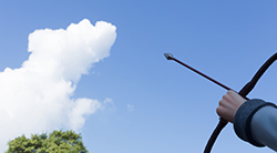 A person points an arrow toward the sky