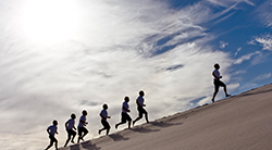 A lead runner carries the rest of the team with him.