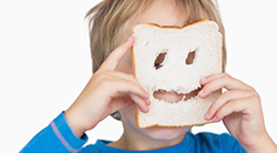 Young boy wears a mask made from bread