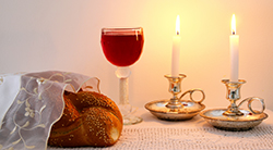 Shabbat candles, wine, and challah