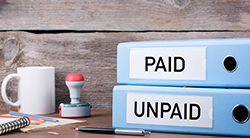Two binders marked paid and unpaid