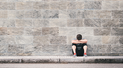 A boy rests with his head down