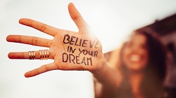 a woman's hand with the message, "believe in your dream" written on it