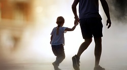 silhouette of father and child walking