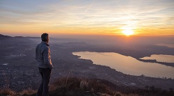 a man gazes out at the sunset