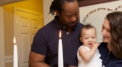 a family lighting candles for Shabbat