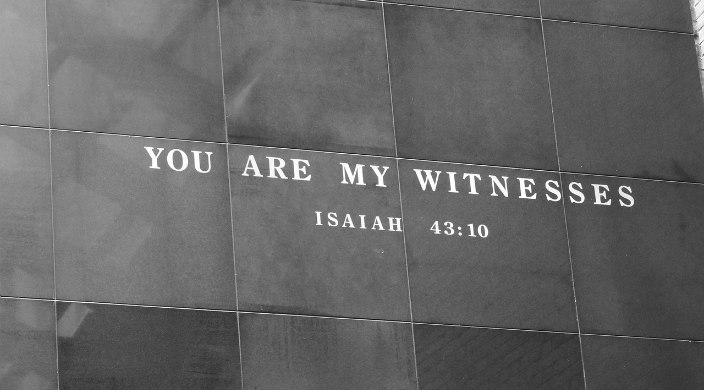 Stone wall engraved with a quote from Isaiah reading YOU ARE MY WITNESSES
