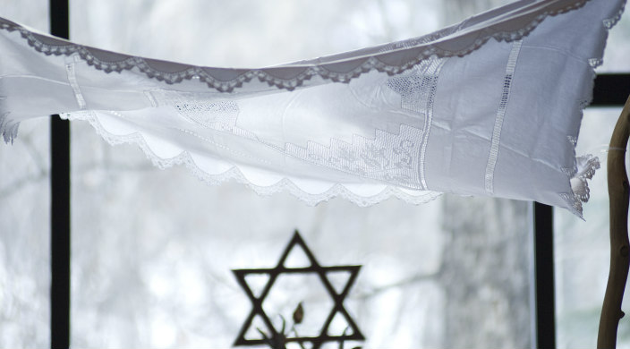 White cloth chuppah with Jewish star in the background