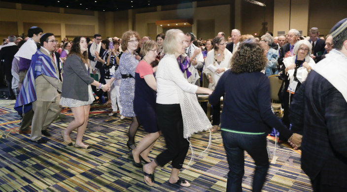 Worshippers doing a hora style dance around the sanctuary