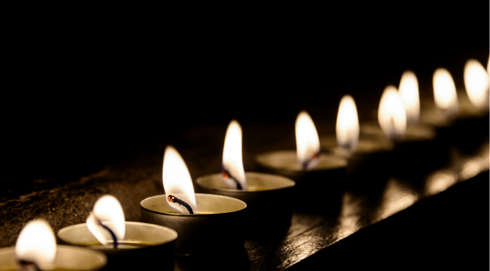 A row of small candles, all lit